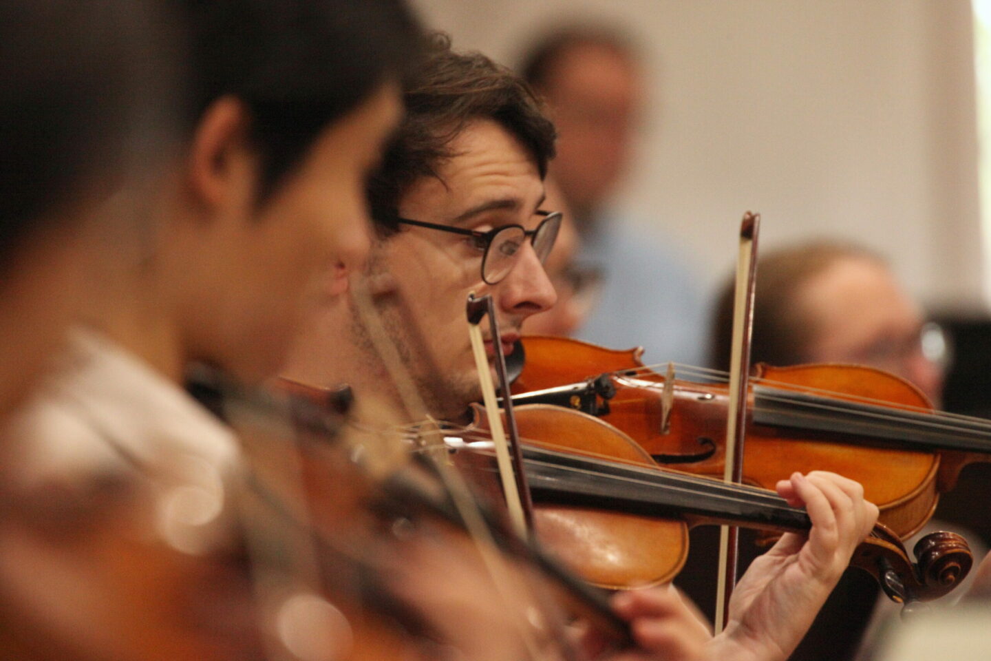 A student violinist playing in section.